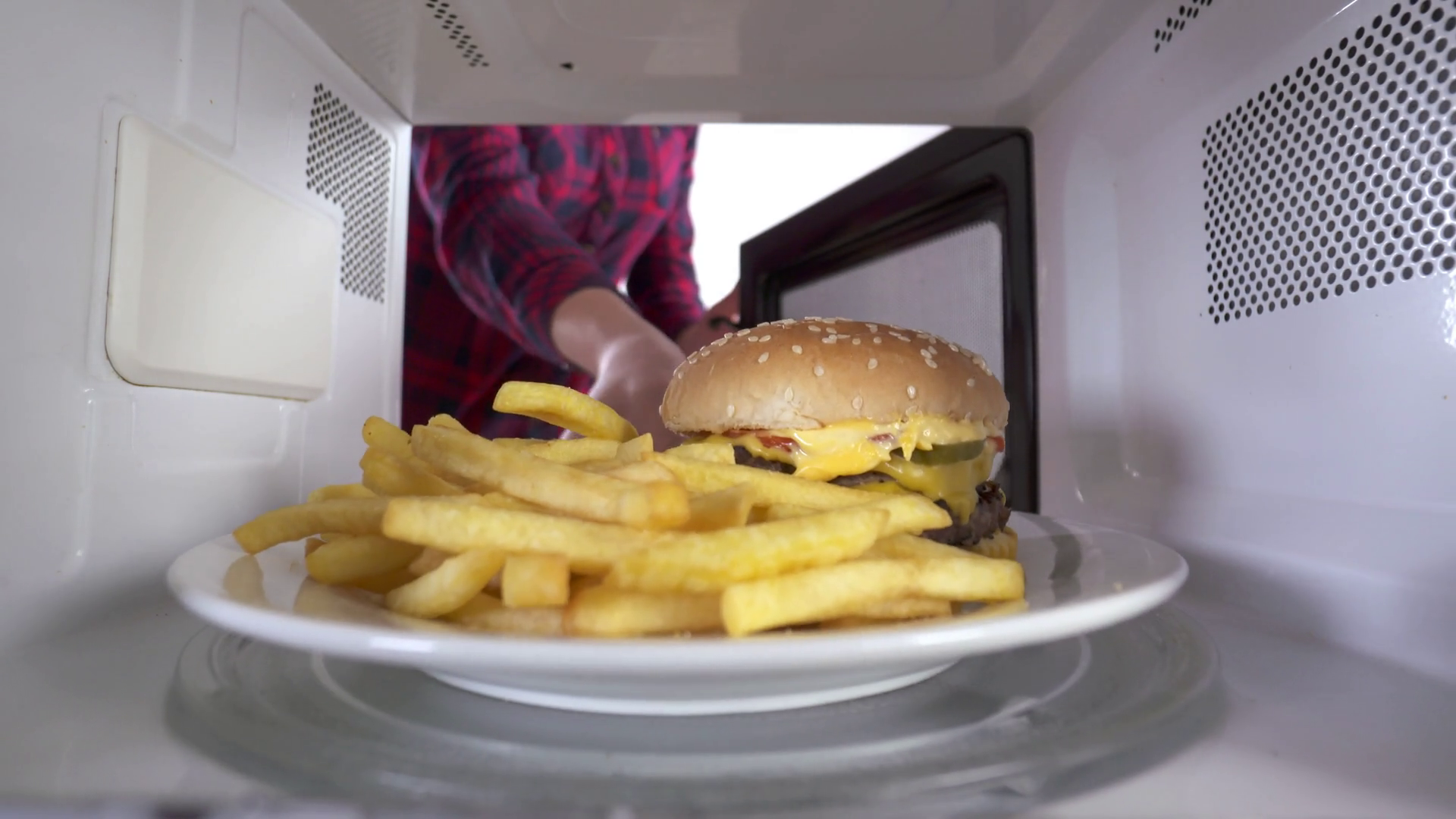 egirl using microwave to reheat food double hamburger with french fries reheating inside microwave oven 1